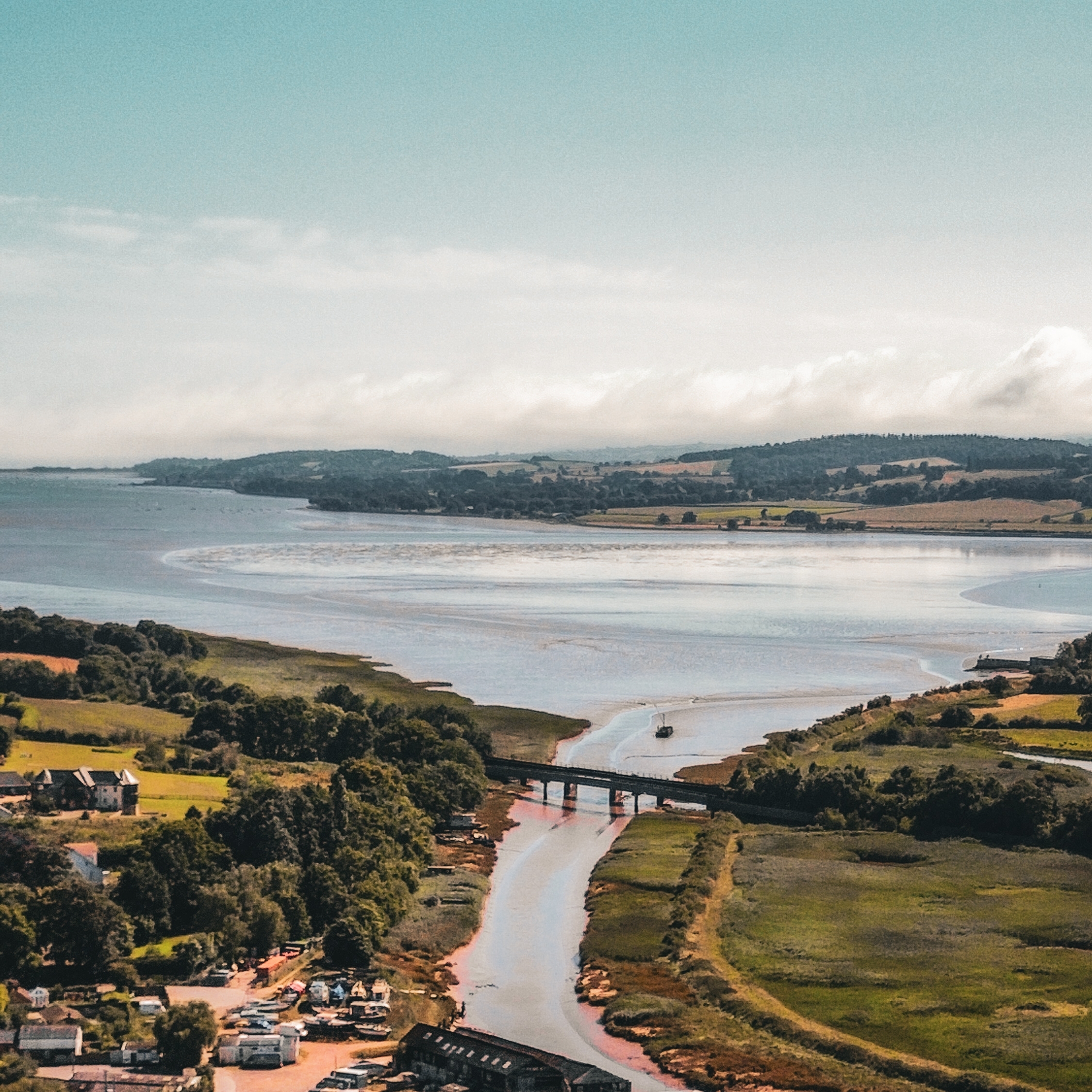 Aerial view of the River Exe estuary in Devon with a bridge crossing the river at low tide
